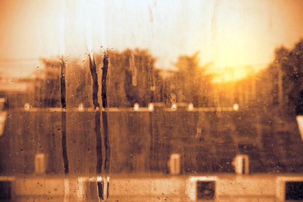 Hard water stains and mineral streaks on residential window glass